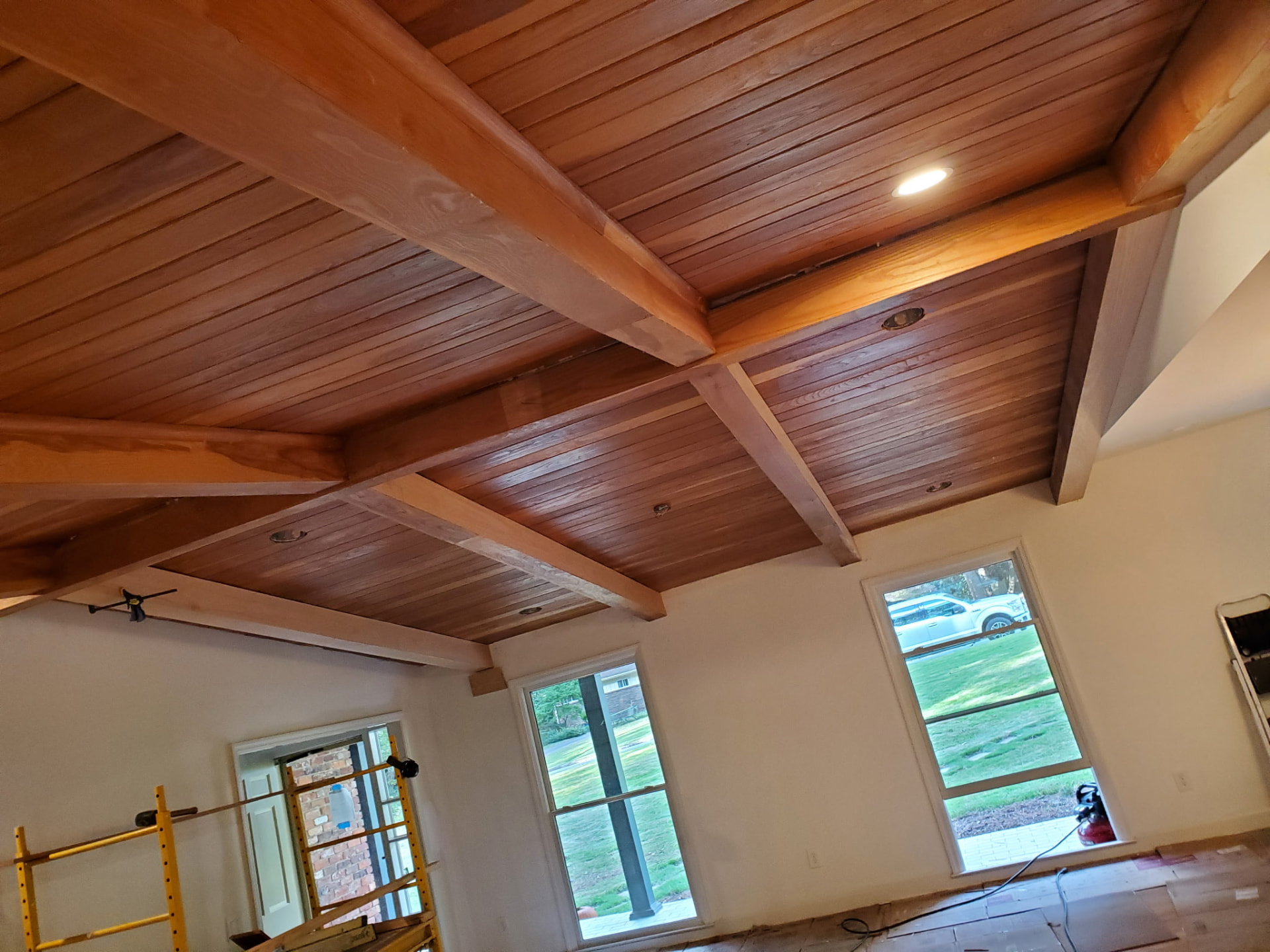 Finished wood ceiling with exposed beams by O'Sean Construction